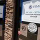 FEMA Disaster Recovery signs direct residents to help in Rainelle, W. Va., in August 2016. A former West Virginia nonprofit director is headed to prison for defrauding FEMA of $18,000 in disaster funds.